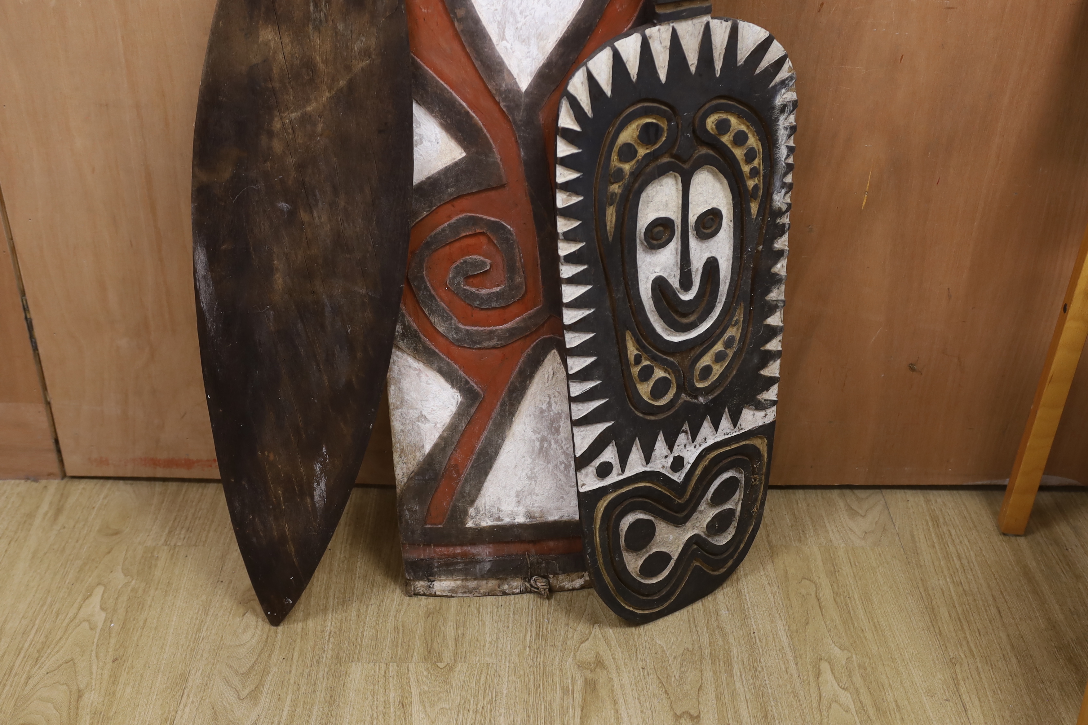 Three Papua New Guinea painted wooden shields, tallest 164cm